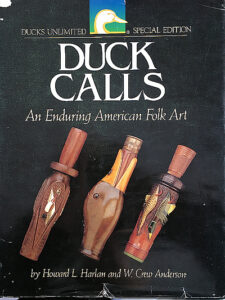Cover of the book "duck calls: an enduring american folk art" featuring images of various decorative duck calls.